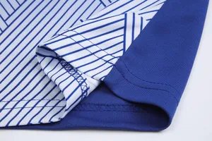 Close-up of breathable football jersey fabric with precise stitching and striped pattern.
