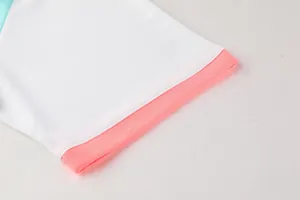 Close-up view of the breathable mesh texture and pink cuff detail on a white sports jersey