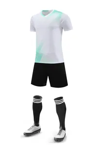Full set of white soccer jersey, black shorts, socks and cleats on white background