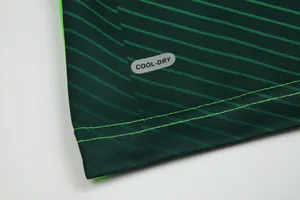 Close-up of soccer jersey hem with COOL-DRY fabric technology and vibrant green stitching