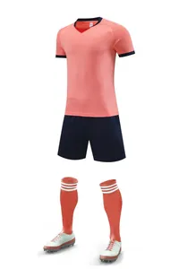 Full football kit set including jersey, shorts, and socks in coral and navy blue colors
