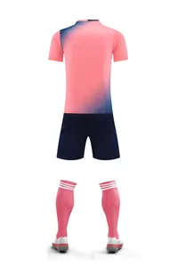 Back view of a pink and blue gradient soccer jersey with navy shorts and socks