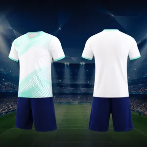 Detailed front and back view of white soccer jersey with cyan waves and navy shorts