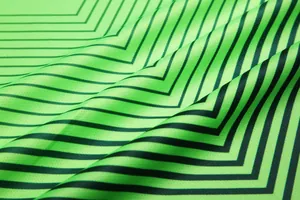 Close-up detail of neon green football jersey fabric with black chevron stripes