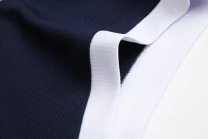 Dettaglio ravvicinato del tessuto mesh blu navy traspirante con bordo bianco a coste