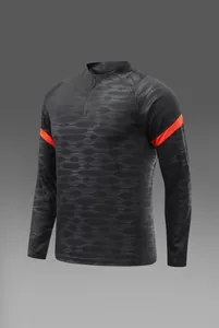 Détail du maillot d'entraînement de football gris avec des accents orange