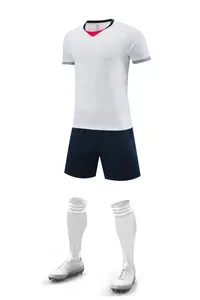 Detail view of professional white and navy blue soccer uniform kit set with cleats