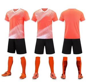 Orange and white soccer uniform set including jersey, shorts, socks, and cleats