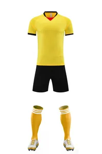 Professional soccer uniform set including yellow jersey, black shorts, socks, and cleats.