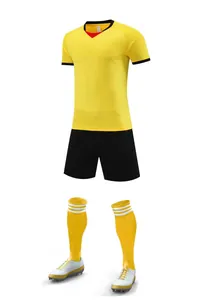 Professional yellow soccer jersey set including black shorts, matching socks, and cleats.