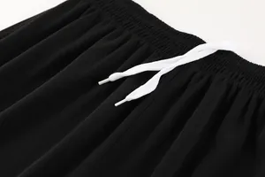 Close-up of black breathable football shorts with elastic waist and white drawstring