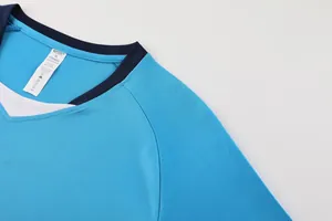 Close-up detail of blue soccer jersey neckline showing mesh fabric texture