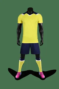 Professional quick-dry yellow soccer jersey set with shorts and socks on mannequin