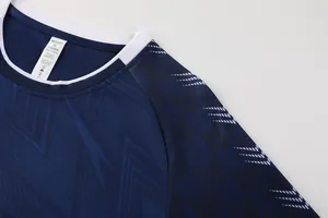 Gros plan montrant le tissu respirant et le motif en V sur ce maillot de football bleu