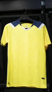 Close-up detail of a yellow quick-dry soccer jersey with embossed geometric patterns