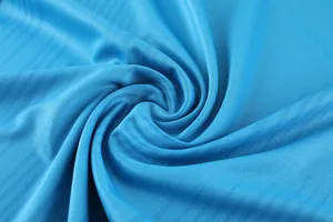 Macro detail of premium blue breathable mesh fabric for professional soccer training jersey