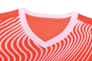 Detail view of the V-neck collar on an orange wavy striped breathable soccer jersey