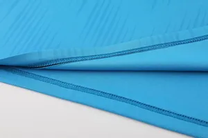 Detailed close-up view of precision double-stitching on breathable athletic fabric hem