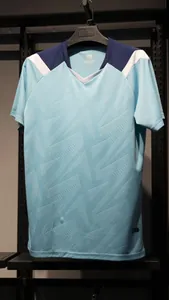 Detail view of light blue quick-dry soccer jersey with geometric textured pattern