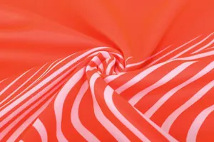 Macro detail of breathable mesh fabric on orange football jersey with pink stripes