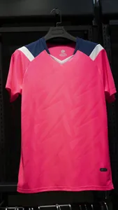 Detail view of a pink quick-dry football jersey with geometric patterns and a classic V-neck