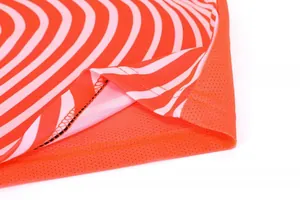 Detail shot showing the precise stitching and breathable orange mesh fabric of the soccer jersey