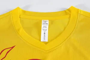 Close-up of the neckline and care label of a yellow mesh sports basketball jersey