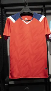 Orange quick-dry soccer jersey detail with embossed geometric pattern and v-neck design