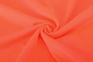 Close-up of breathable orange mesh fabric for professional soccer jersey uniforms