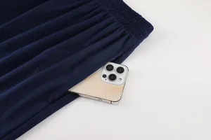 Close-up of navy blue soccer shorts pocket showing deep storage capacity for a smartphone.
