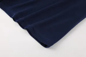 Close-up detail of navy blue mesh fabric hemline on a sports football jersey