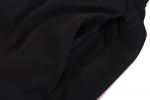 Close-up detail of black breathable mesh fabric and pocket on sports soccer shorts