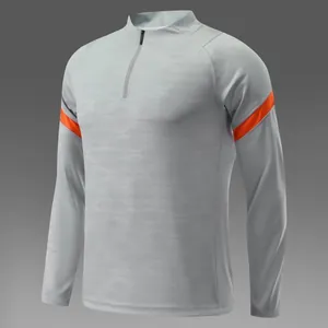 Haut de football gris à manches longues pour hommes avec rayures orange et demi-zip
