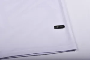 Macro detail of white quick-dry football jersey fabric and authentic original product patch