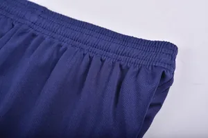 Close-up of navy blue quick-dry soccer shorts showing elastic waistband and mesh texture