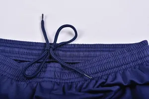 Close-up view of navy blue football shorts waistband with elastic band and adjustable drawstring