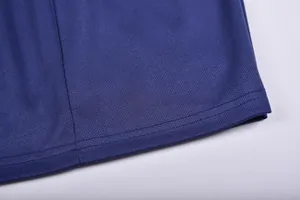 Close-up of navy blue football jersey hem showing durable stitching and breathable fabric