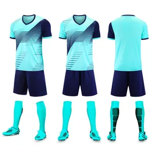 Detailed three-angle display of a cyan and navy blue youth soccer uniform kit set