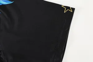 Close-up of black breathable mesh sleeve with star detail on a quick-dry sports jersey