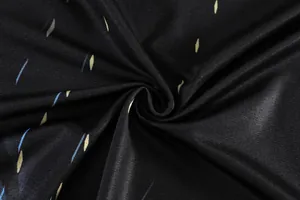 Close-up macro view of black breathable sports fabric with blue and yellow diamond pattern