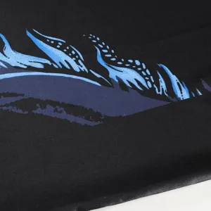 Close-up of black breathable table tennis jersey with blue feather graphic print