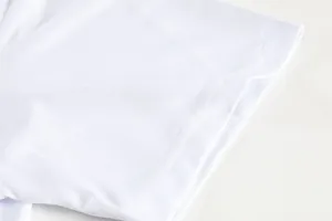 Detail of white quick-dry badminton jersey sleeve with fine mesh texture