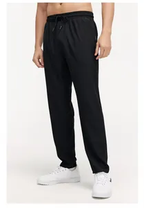 Detailed view of black breathable elastic sports pants with an adjustable drawstring waist
