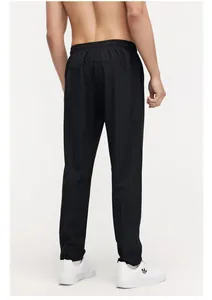Rear view of black breathable elastic athletic pants for men and women's casual wear
