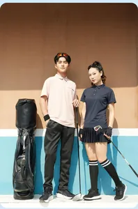 Professional couple in quick-dry moisture-wicking sports polo shirts on a golf course.