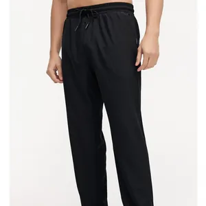 Men's and women's breathable elastic sports pants with drawstring in black.