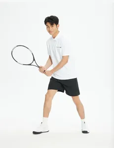 Male athlete in white polo and black quick-dry sports shorts holding a tennis racket