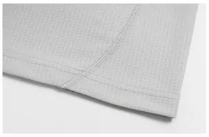 Macro detail of breathable mesh fabric and durable flatlock stitching on sports T-shirt