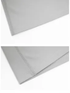 Vue macro des coutures de qualité et de la texture respirante du t-shirt de sport gris