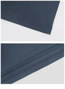 Detailed view of the precise double-needle stitching and hem on a navy blue polo shirt.